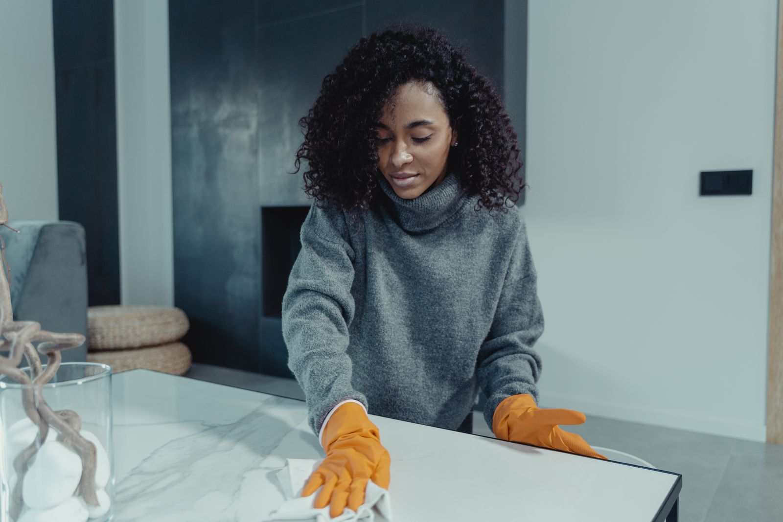 Domestic service professional cleaning a modern home table